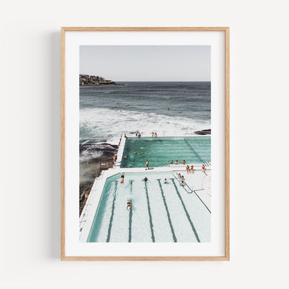 Serene Ocean Poolside Retreat with Bathers and Majestic Waves